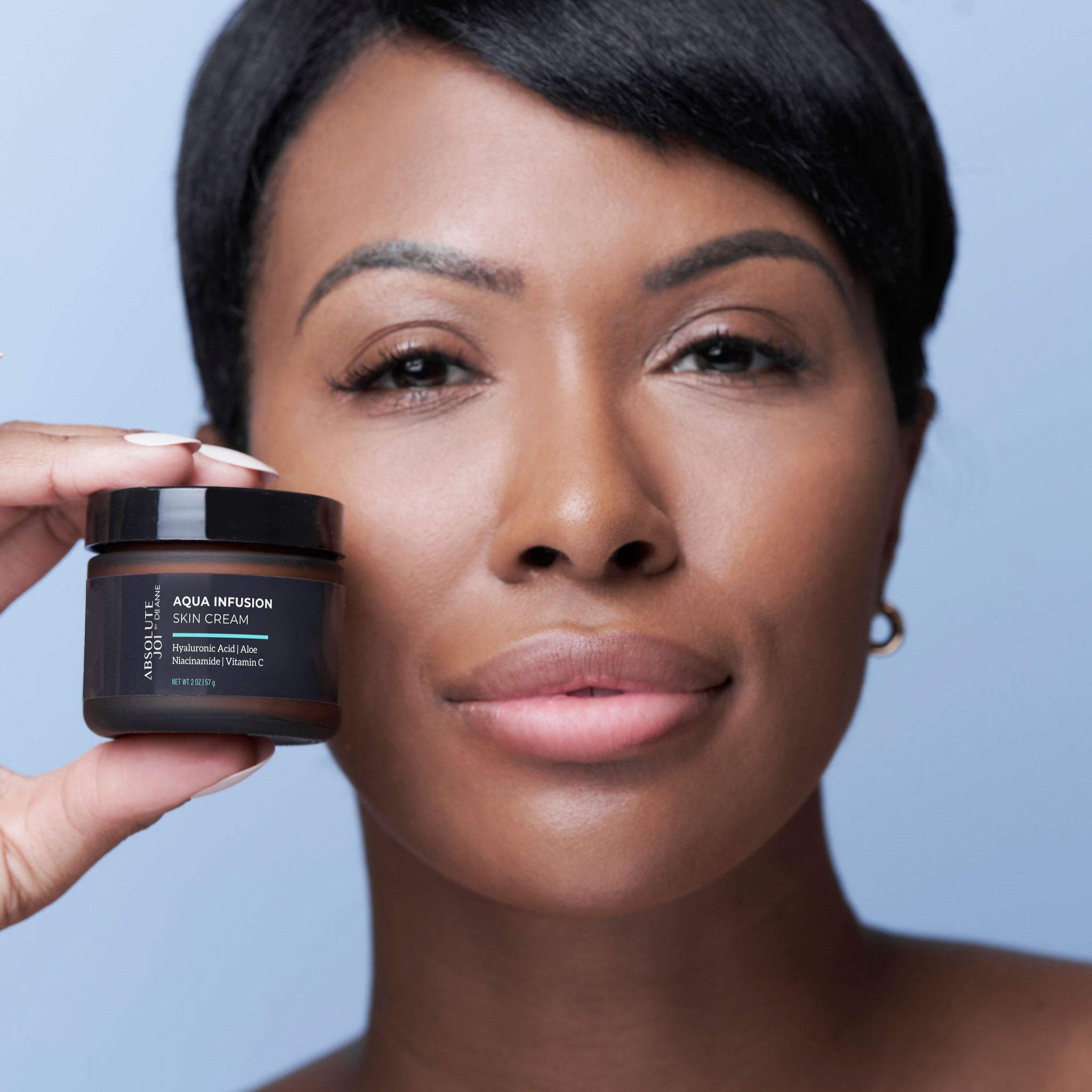 Ageless Beauty Bundle - AbsoluteJOI SkinCare  Woman holding Aqua Infusion Skin Cream